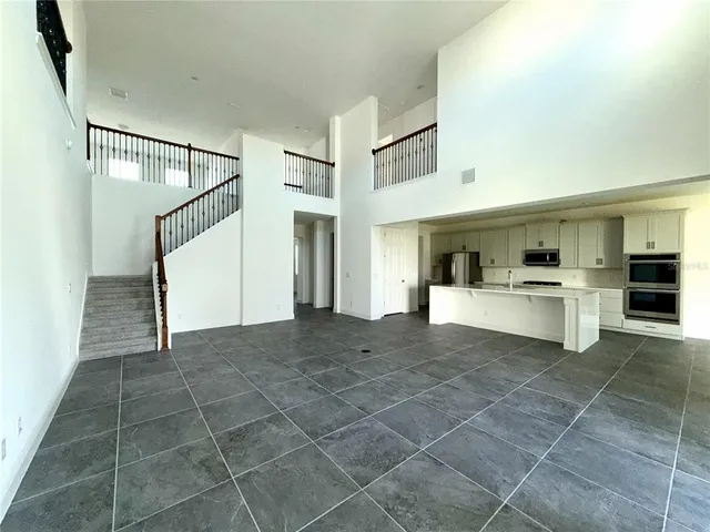 a view of a kitchen with furniture and an empty room