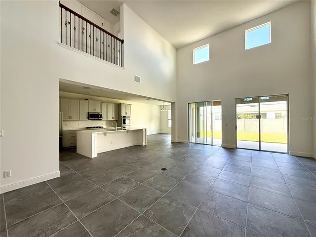 a view of an empty room with a kitchen