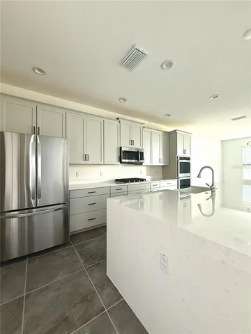 a kitchen with appliances cabinets and a counter top space