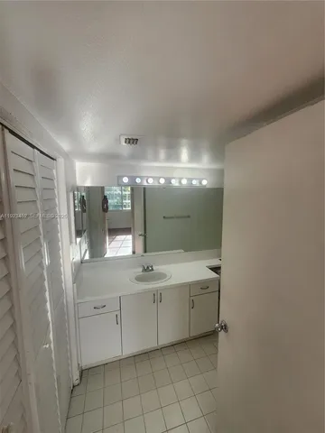 a bathroom with a double vanity sink and mirror