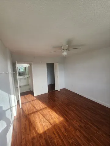 a view of an empty room and wooden floor