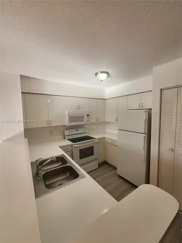 a kitchen with a stove and a refrigerator