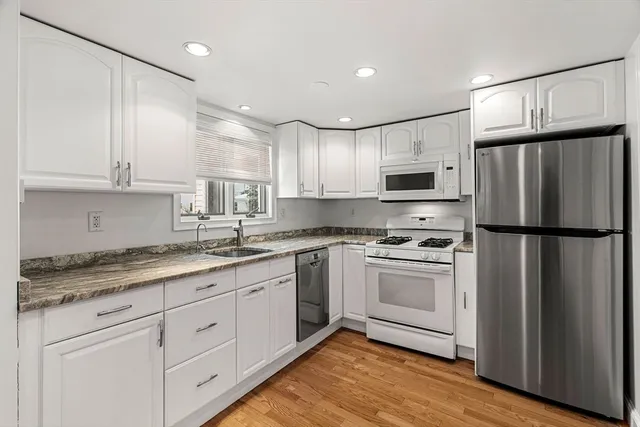 a bathroom with a granite countertop sink vanity and mirror
