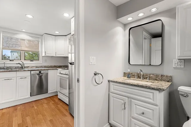 a view of hallway with stairs and wooden floor