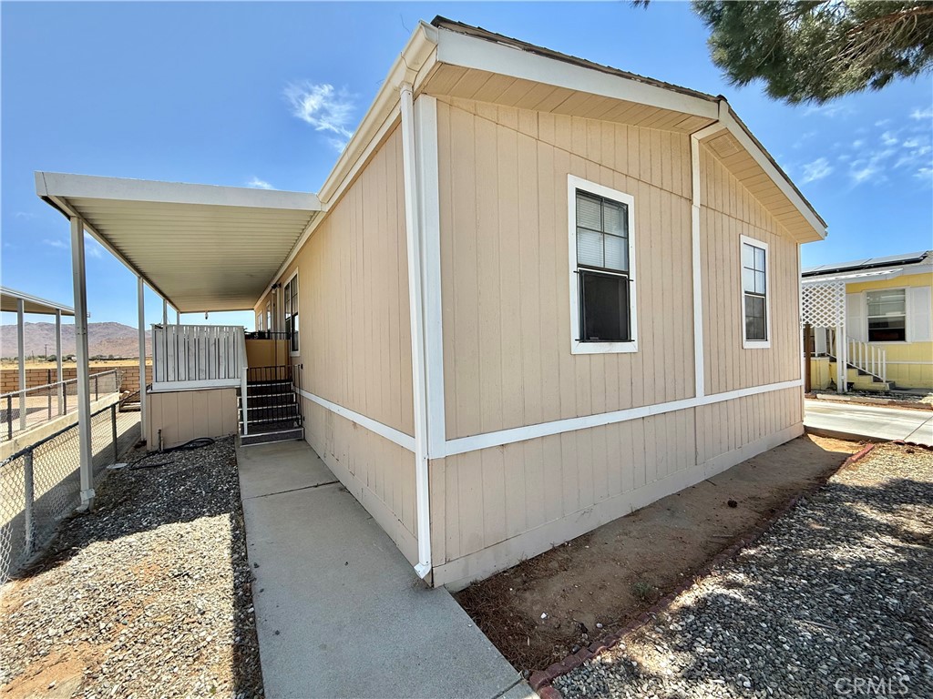 22020 Nisqually Road, Unit 65 Apple Valley, CA 92308 - Photo 2 of 14 a view of a house with wooden floor next to a road