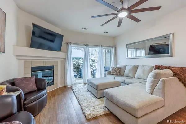 a living room with furniture and a fireplace