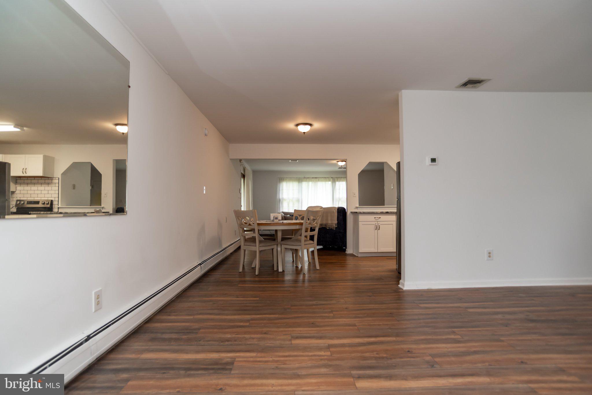 77 Cardinal Road Levittown, PA 19057 - Photo 5 of 37 a view of a room with wooden floor furniture and windows