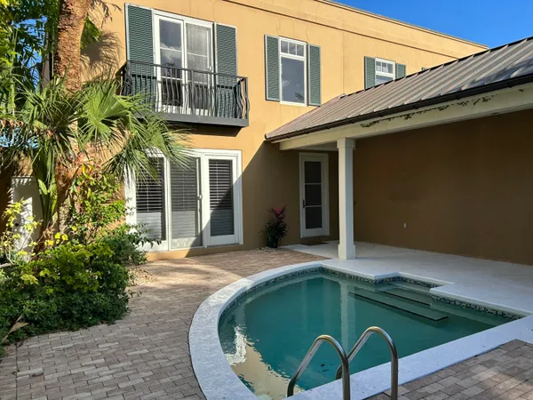 a house with swimming pool in front of it