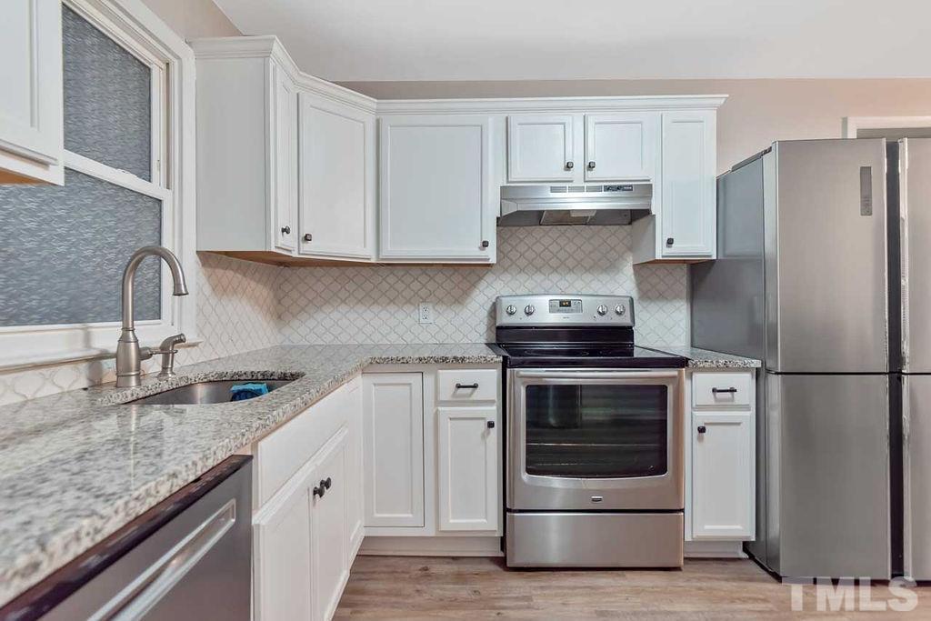 2613 Elmhurst Circle Raleigh, NC 27610 - Photo 15 of 29 a kitchen with stainless steel appliances granite countertop a stove a refrigerator and a sink