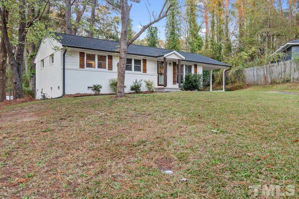 2613 Elmhurst Circle Raleigh, NC 27610 - Photo 2 of 29 a view of a yard in front of a house with large tree