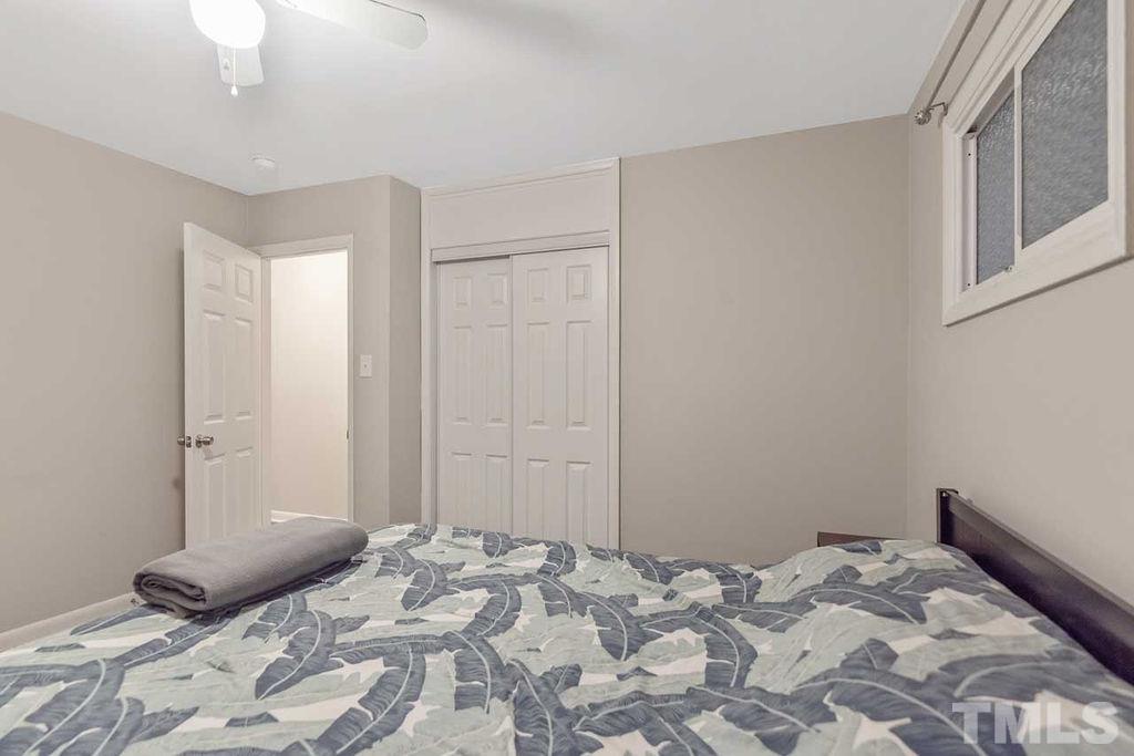 2613 Elmhurst Circle Raleigh, NC 27610 - Photo 21 of 29 a bedroom with a bed and a window