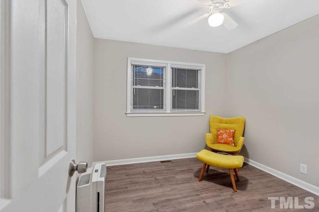 2613 Elmhurst Circle Raleigh, NC 27610 - Photo 23 of 29 a living room with a chair and a window