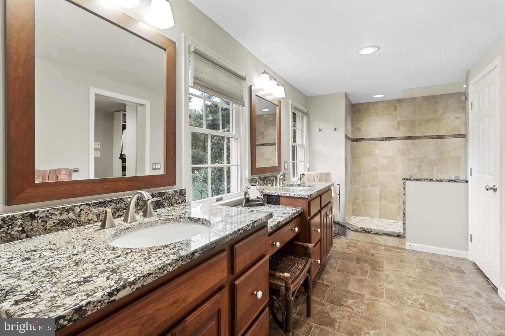 237 Gulph Creek Road Wayne, PA 19087 - Photo 14 of 25 a bathroom with a granite countertop sink a mirror and a shower