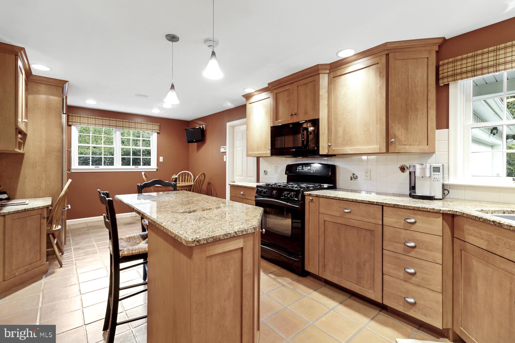 237 Gulph Creek Road Wayne, PA 19087 - Photo 3 of 25 a kitchen with a stove a sink a dining table and chairs
