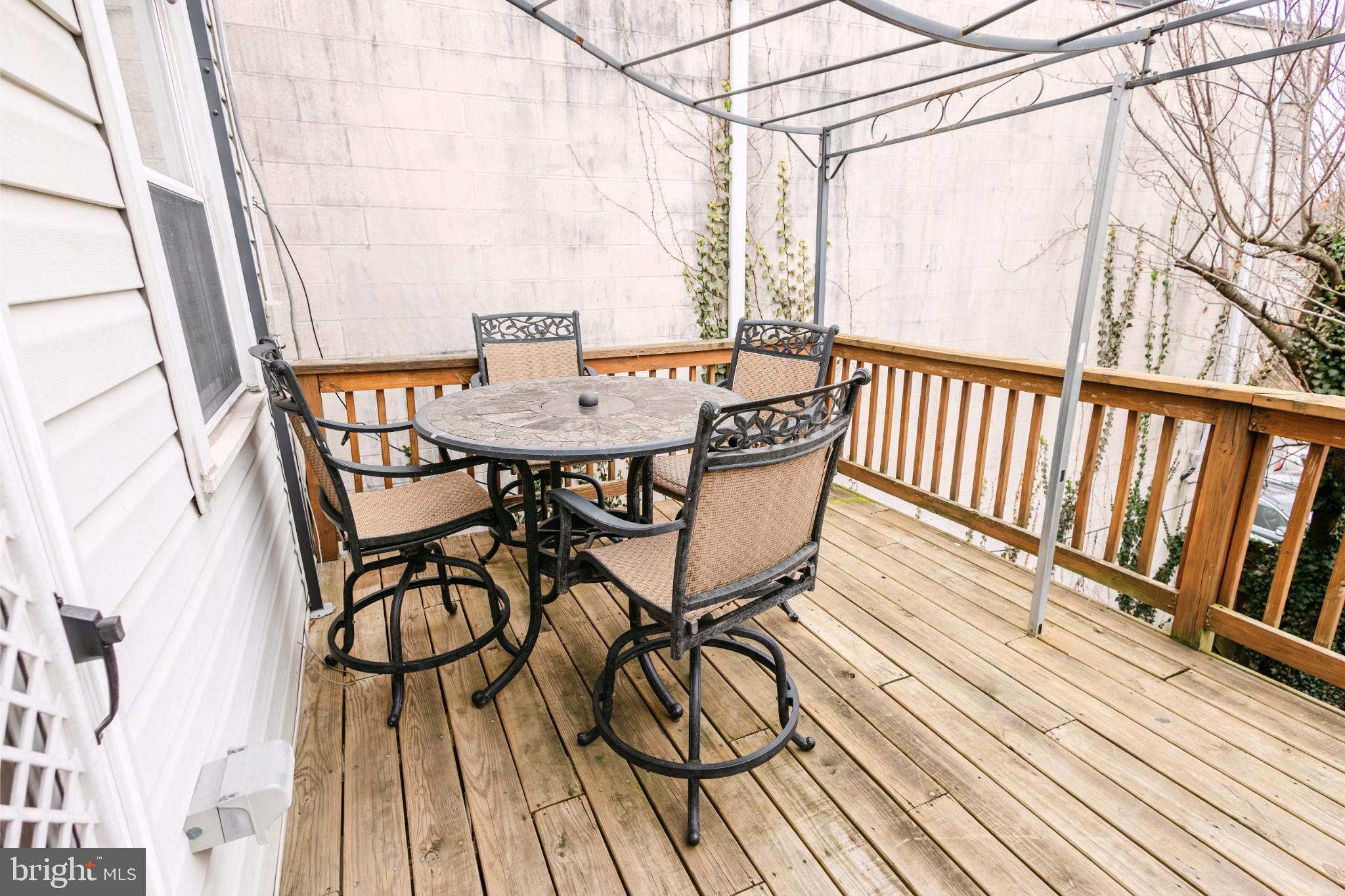 3732 Falls Road Baltimore, MD 21211 - Photo 11 of 46 a view of balcony with wooden floor and outdoor seating