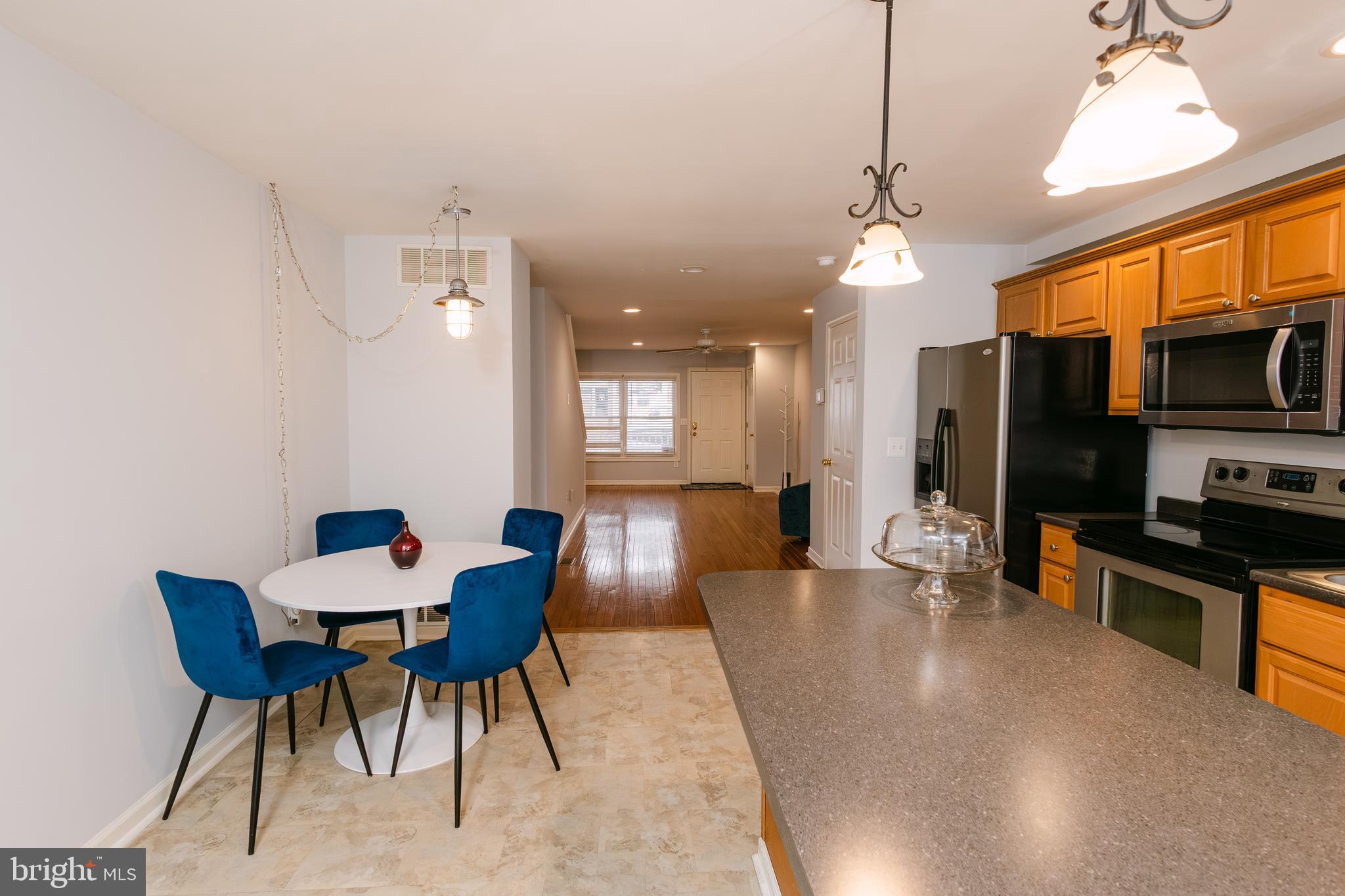 3732 Falls Road Baltimore, MD 21211 - Photo 12 of 46 a view of a dining room with furniture a chandelier and wooden floor