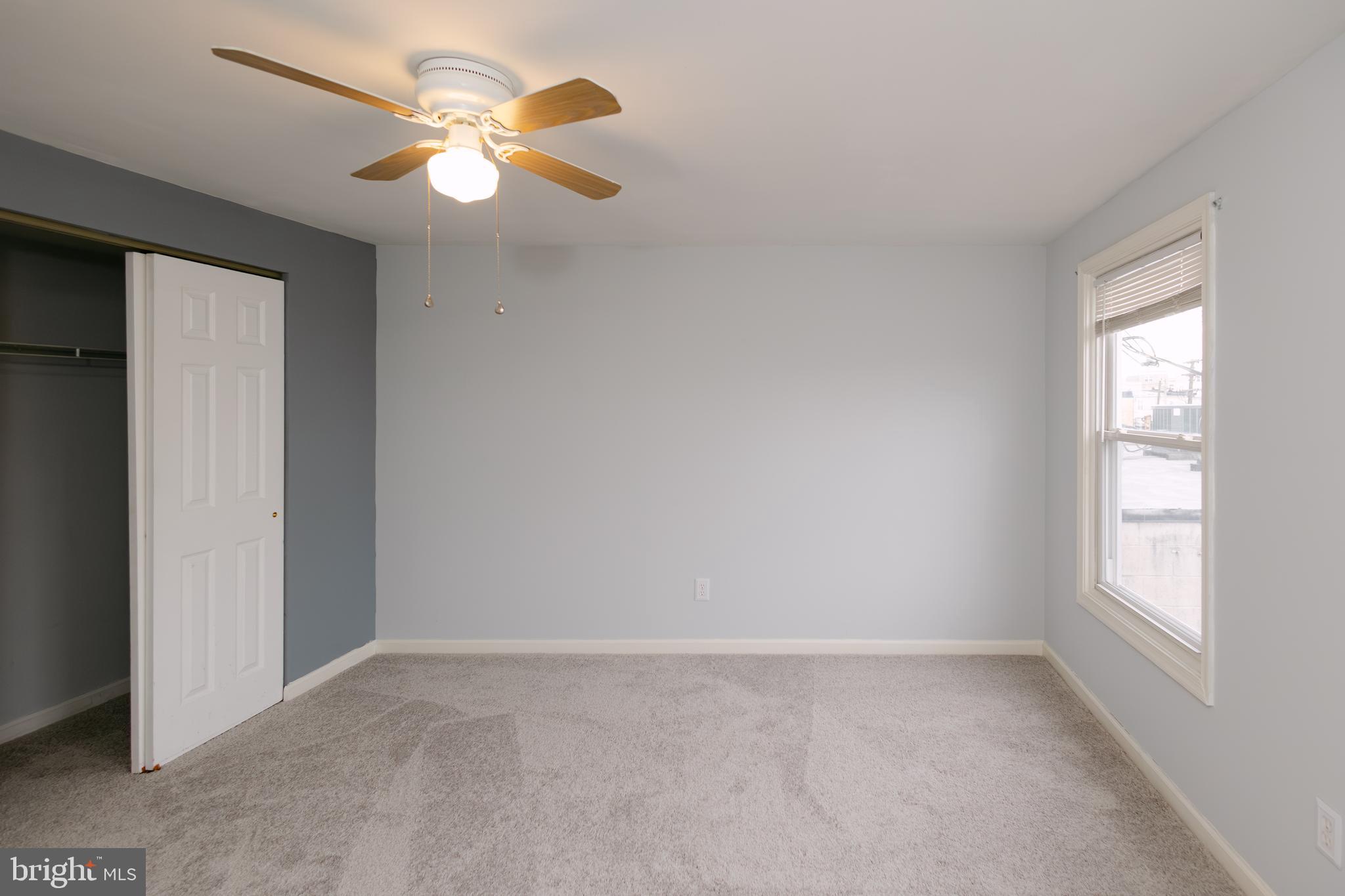 3732 Falls Road Baltimore, MD 21211 - Photo 18 of 46 an empty room with a window and a fan