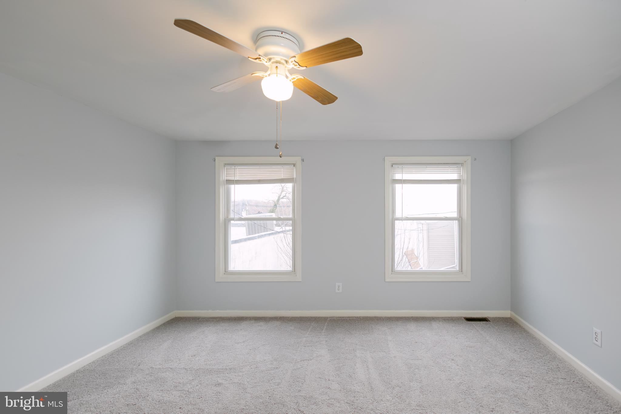 3732 Falls Road Baltimore, MD 21211 - Photo 19 of 46 an empty room with windows and fan