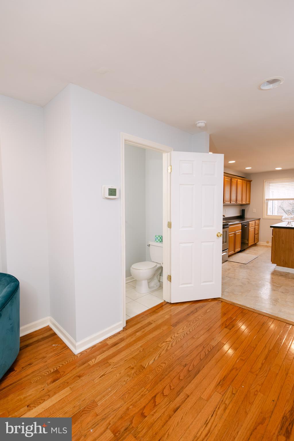 3732 Falls Road Baltimore, MD 21211 - Photo 5 of 46 a view of a livingroom with wooden floor and a kitchen space