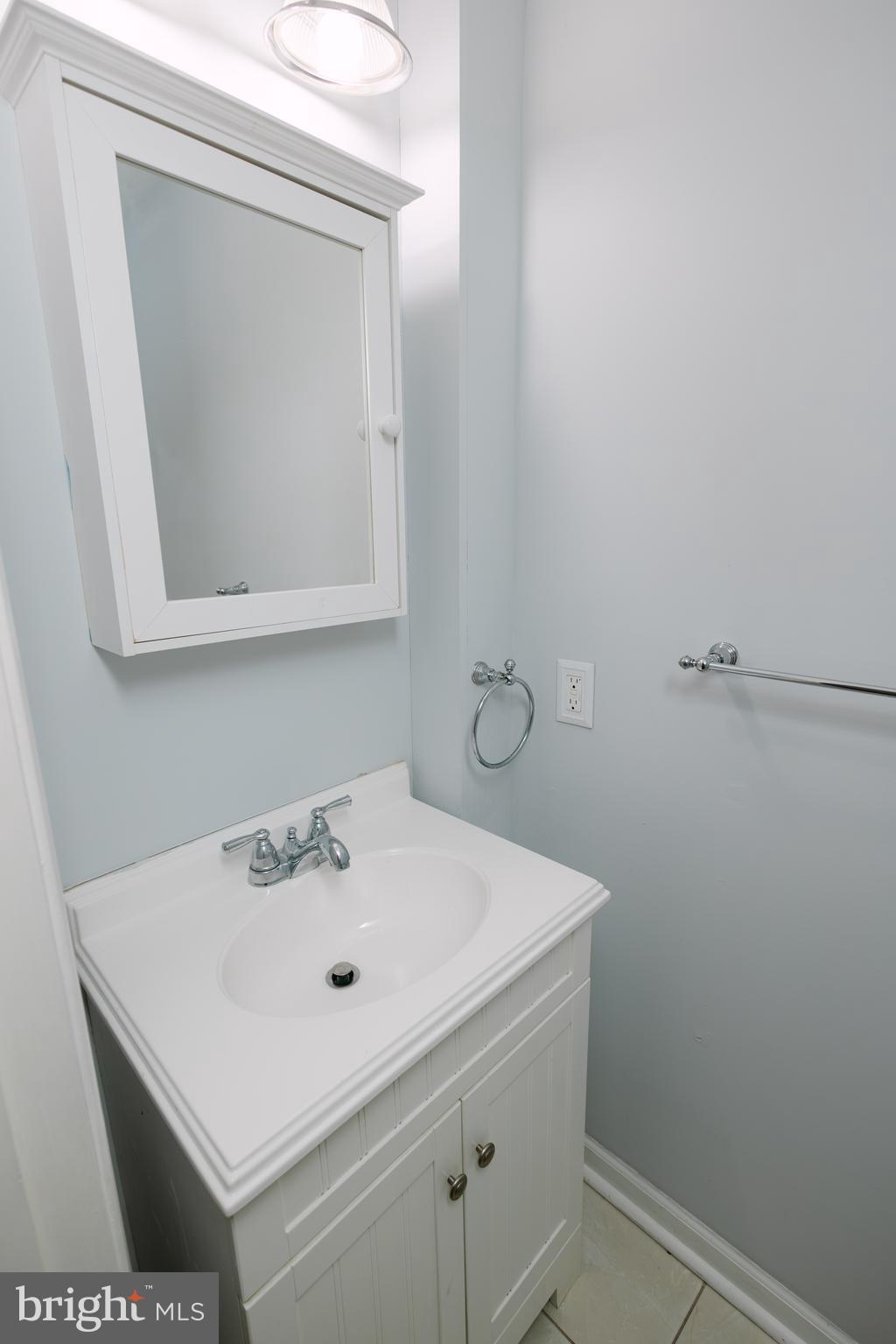 3732 Falls Road Baltimore, MD 21211 - Photo 6 of 46 a white sink sitting under a bathroom mirror