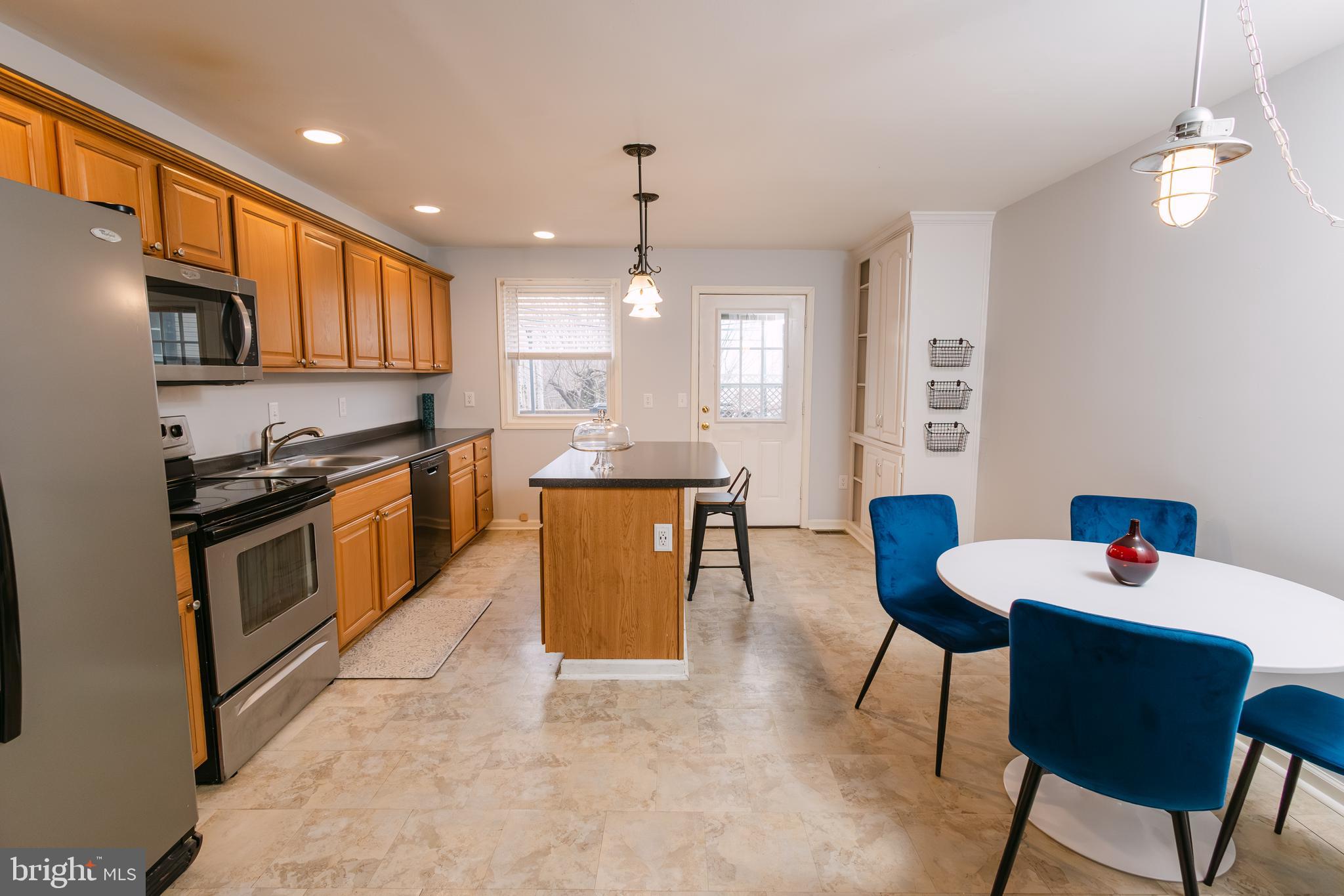 3732 Falls Road Baltimore, MD 21211 - Photo 8 of 46 a kitchen with stainless steel appliances kitchen island granite countertop a sink and cabinets