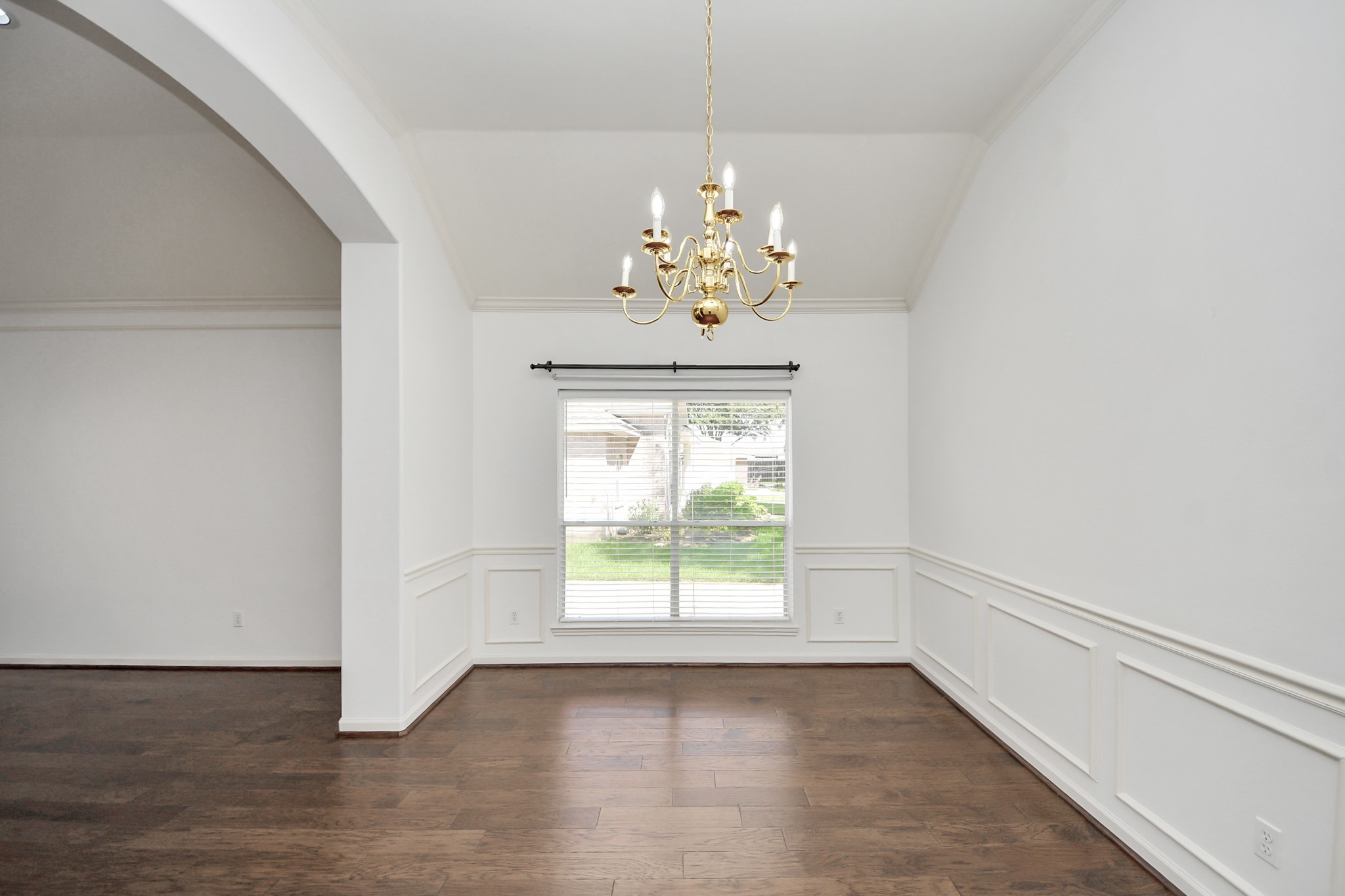 5815 Pheasant Ridge Lane Houston, TX 77041 - Photo 29 of 46 Elegant dining area with rich hardwood floors, a classic chandelier, and large window providing ample natural light.