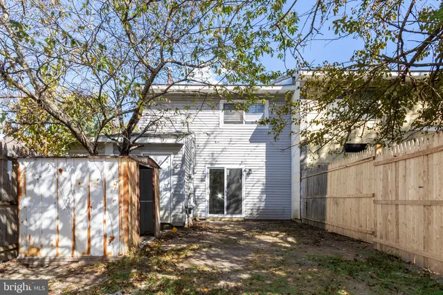 a view of a house with a tree and a yard