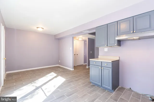 a kitchen with granite countertop a sink a stove and cabinets