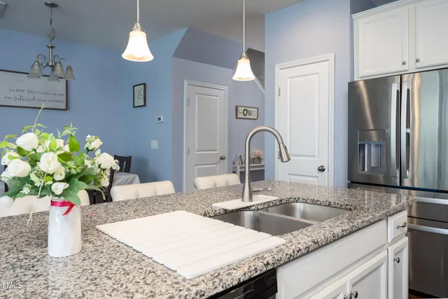 a kitchen with a sink a counter and a refrigerator