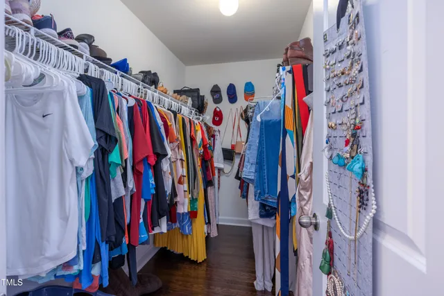 a view of walk in closet with clothes