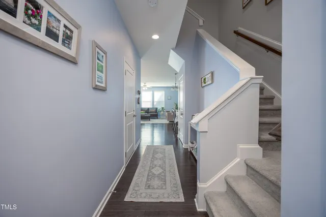 a view of entryway and hall with wooden floor