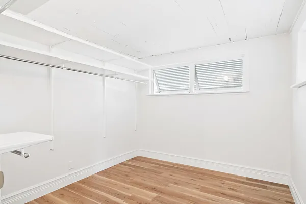 a view of a room with wooden floor