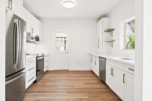 a kitchen with stainless steel appliances a stove and a refrigerator