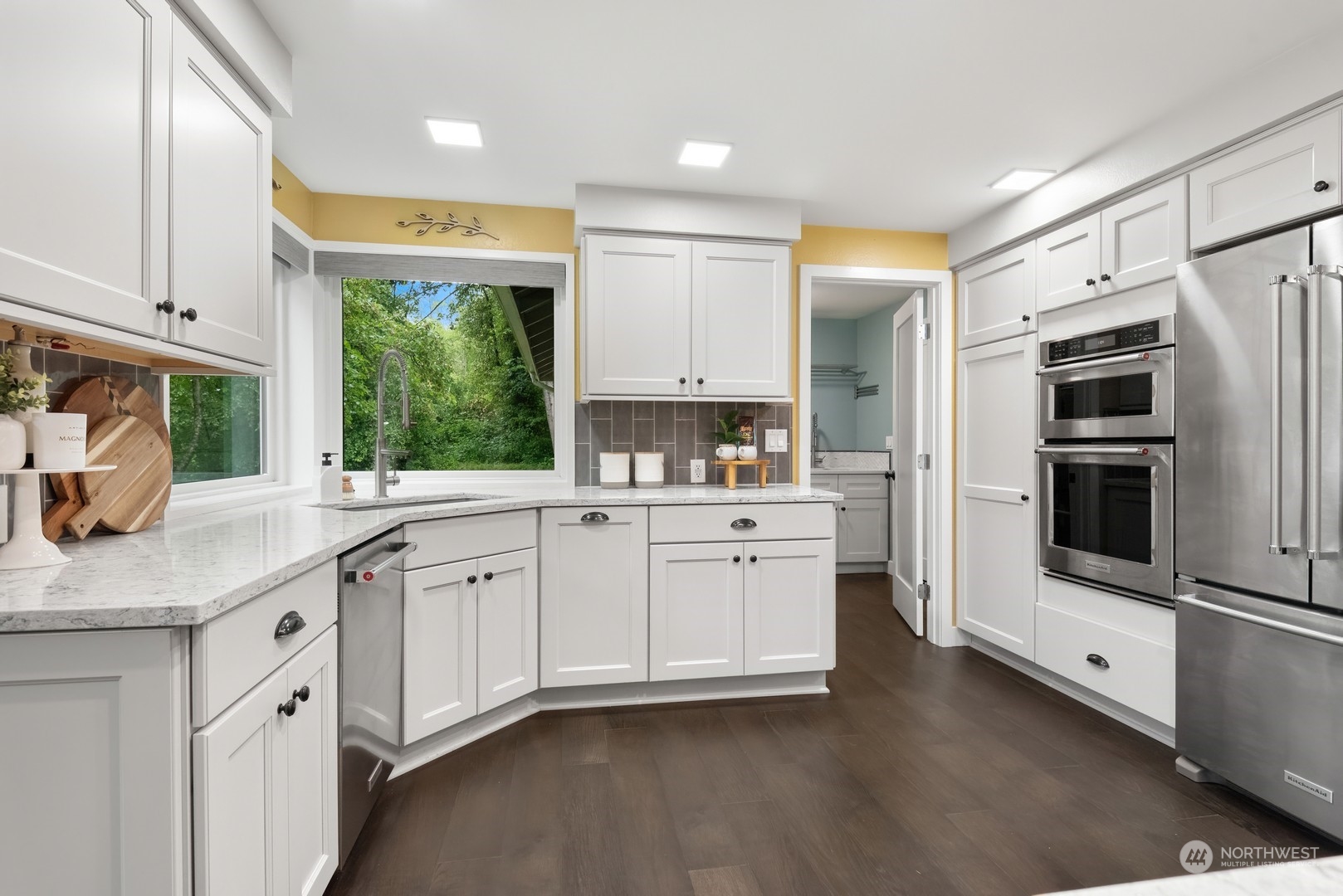24327 Lockwood Road Bothell, WA 98021 - Photo 14 of 40 a kitchen with stainless steel appliances granite countertop a stove a sink and a refrigerator