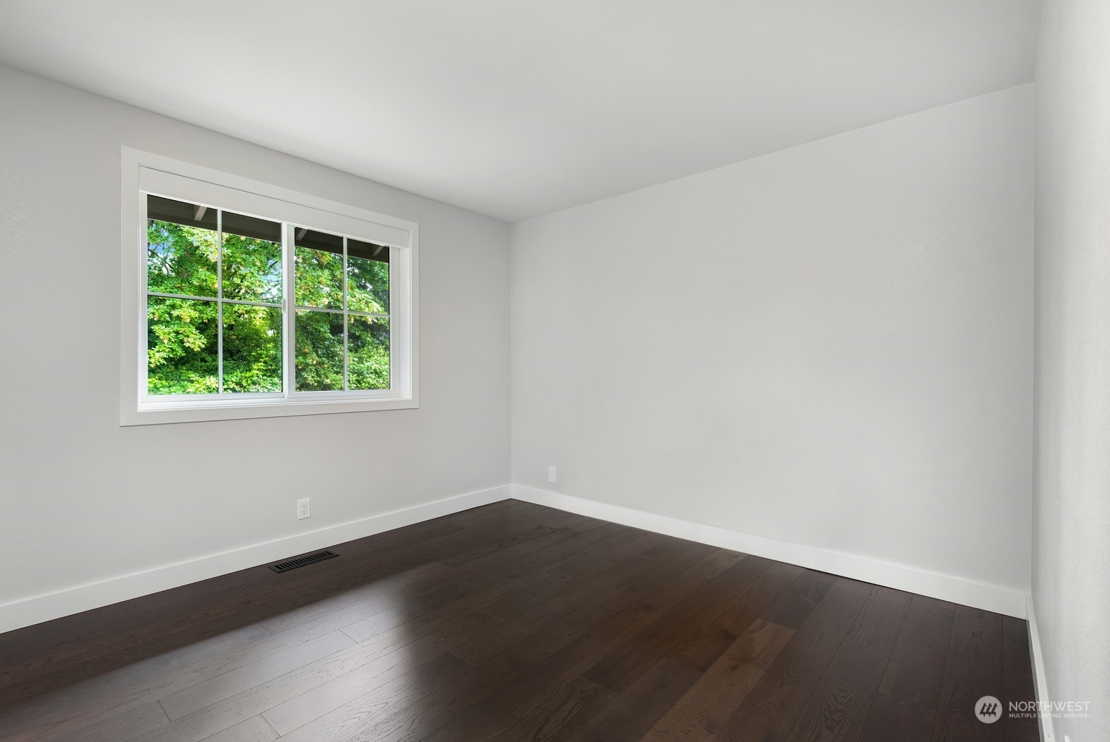 24327 Lockwood Road Bothell, WA 98021 - Photo 25 of 40 an empty room with wooden floor and windows
