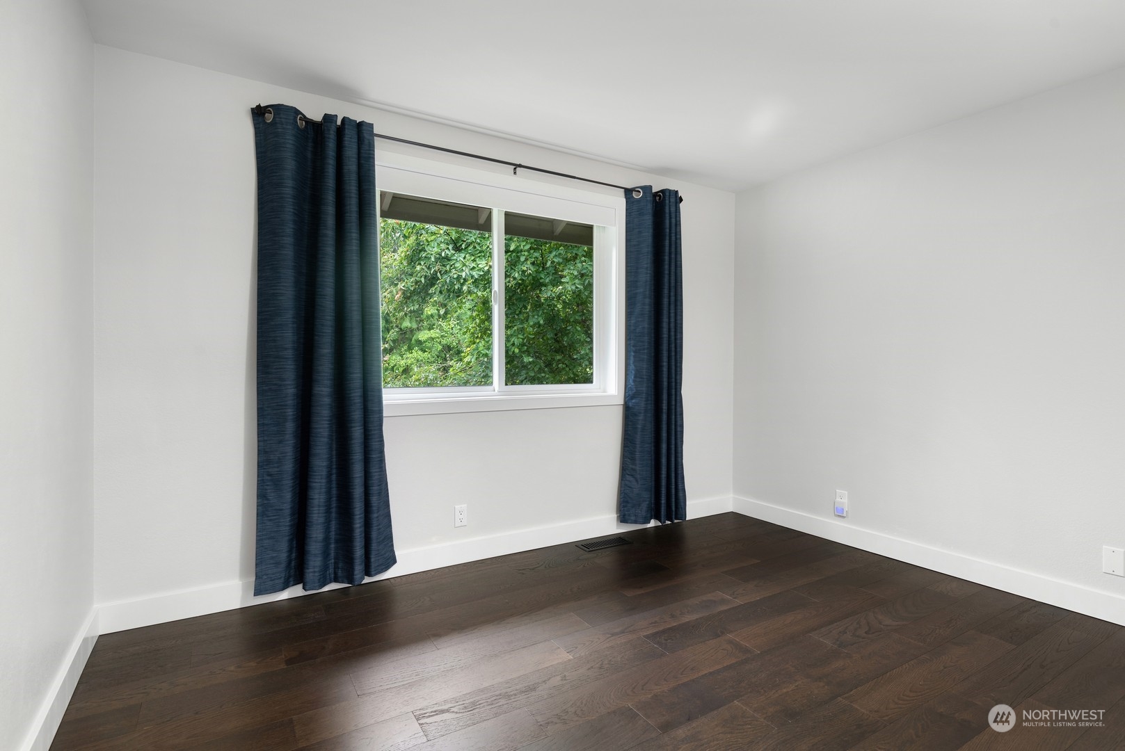 24327 Lockwood Road Bothell, WA 98021 - Photo 26 of 40 an empty room with wooden floor and windows
