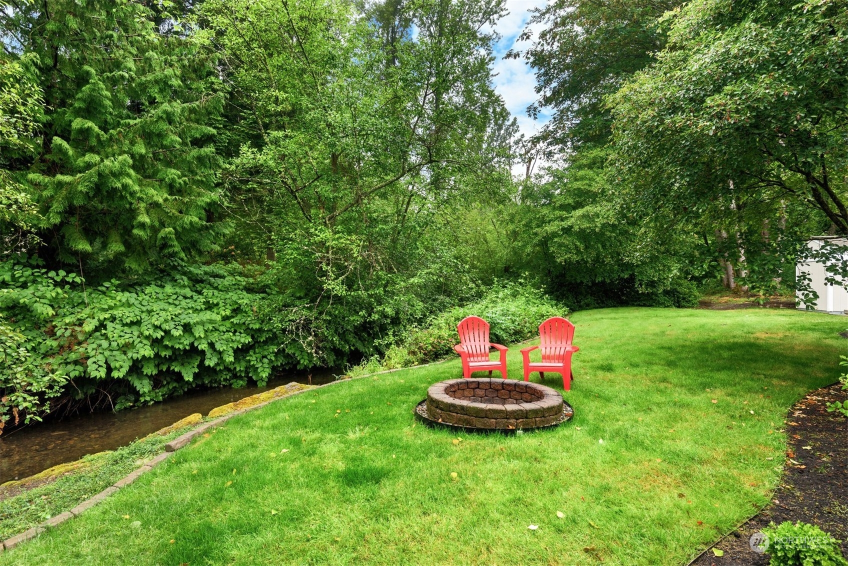 24327 Lockwood Road Bothell, WA 98021 - Photo 35 of 40 a backyard of a house with table and chairs
