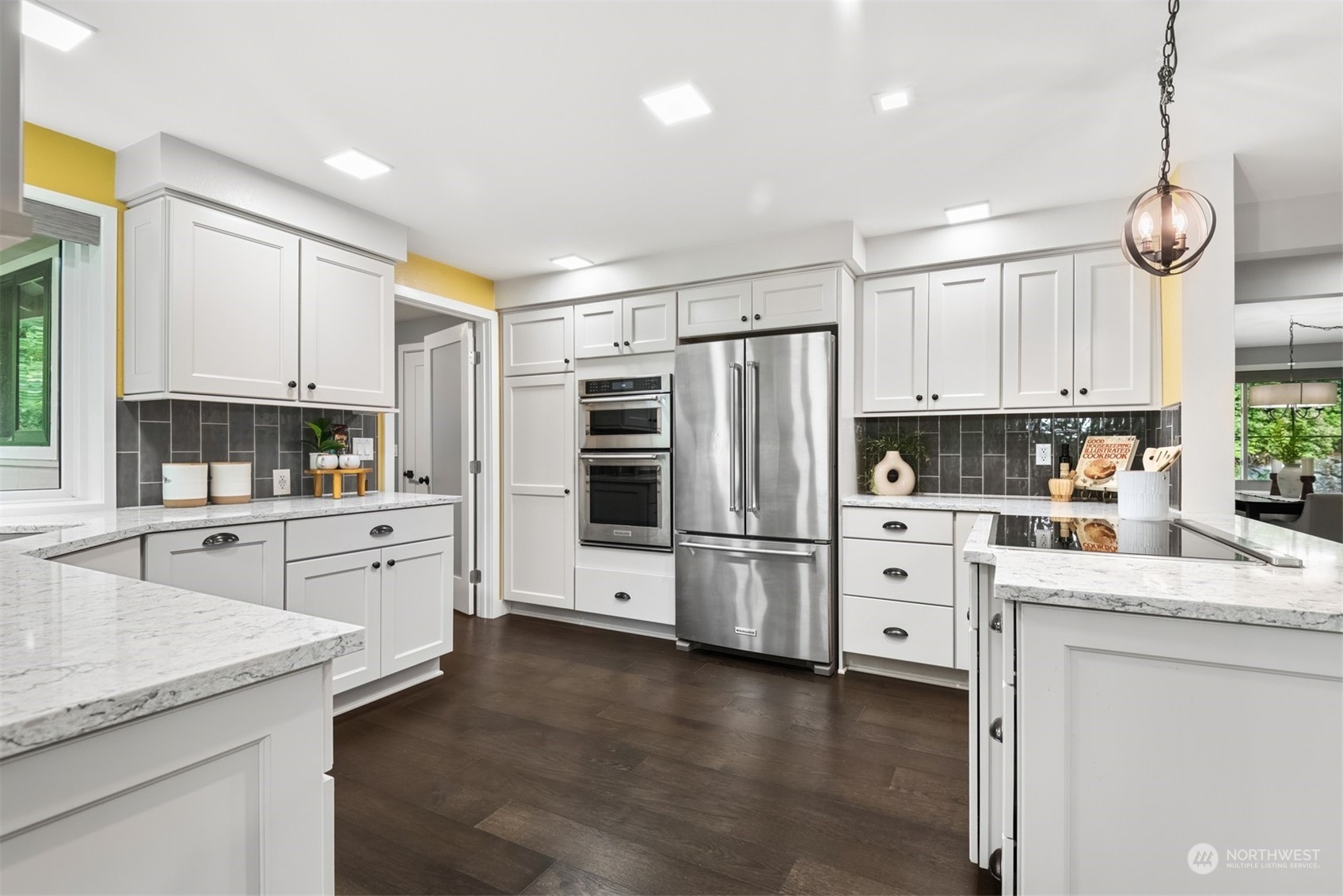 24327 Lockwood Road Bothell, WA 98021 - Photo 9 of 40 a kitchen with white cabinets and stainless steel appliances
