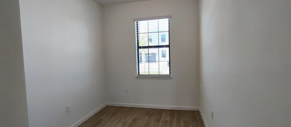 wooden floor and window in an empty room