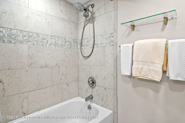 a bathroom with a bath tub and shower