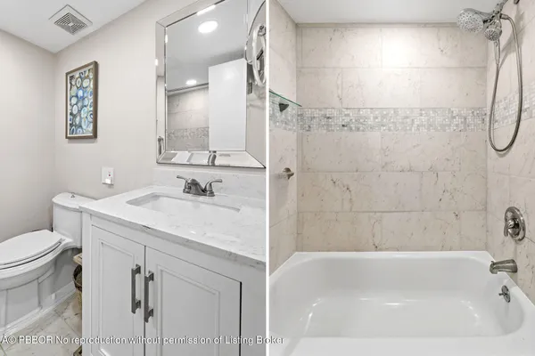 a bathroom with a granite countertop sink a toilet and shower