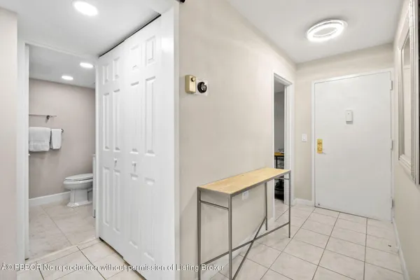 a spacious bathroom with a granite countertop sink a toilet and a mirror