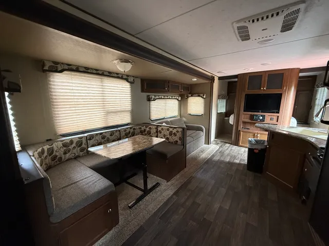 a room with furniture pool table flat screen tv and windows