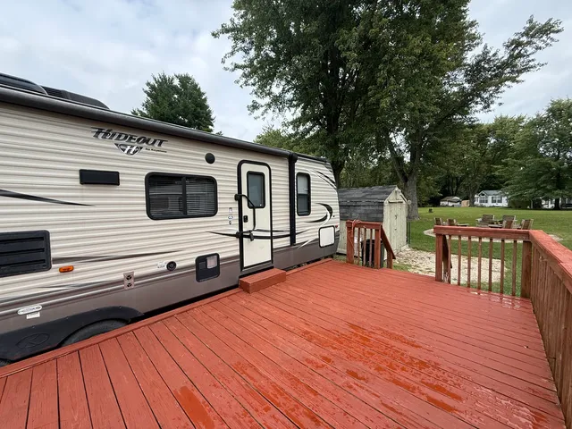 a view of a deck with chairs a barbeque with wooden floor and fence
