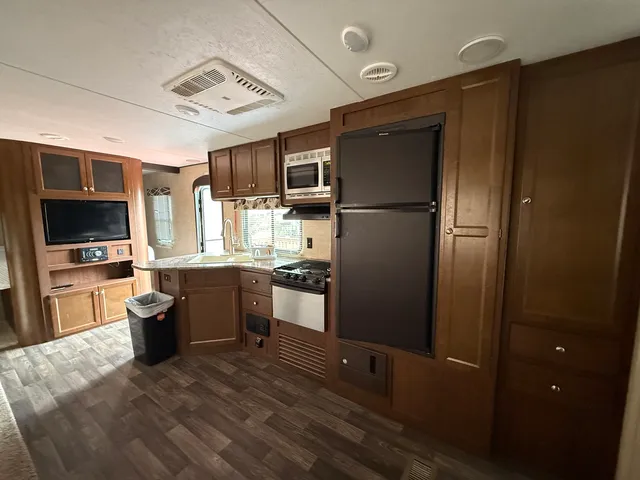 a kitchen with a refrigerator and a sink