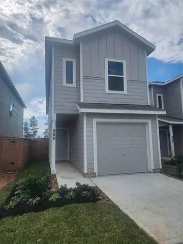 a front view of a house with a garden and plants