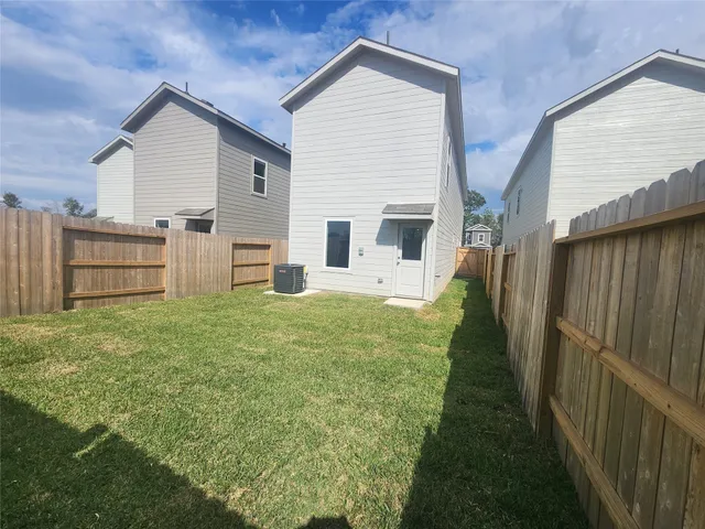 a view of a house with a yard and garage