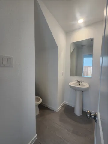 a bathroom with a toilet a sink and window