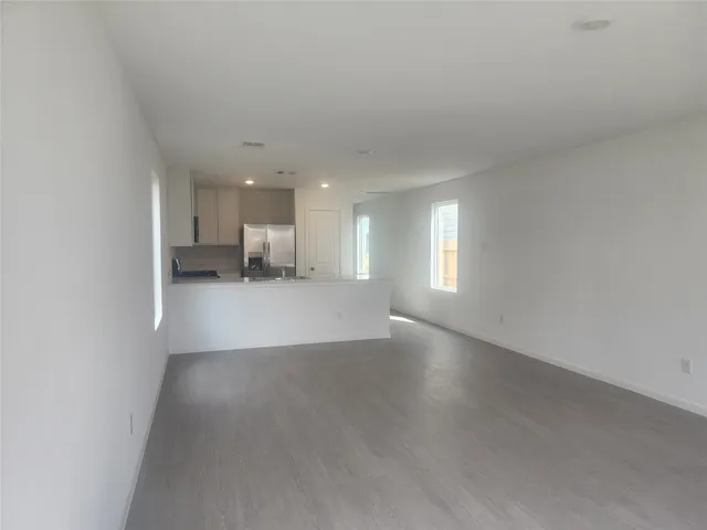 a large kitchen with stainless steel appliances granite countertop a stove a sink and a refrigerator