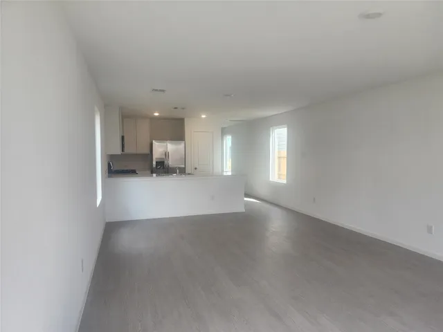 a large kitchen with stainless steel appliances granite countertop a stove a sink and a refrigerator